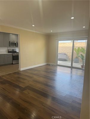 Empty room, Interior, Kitchen, Recessed Lighting, Stainless Steel Appliances, Wood Texture Flooring