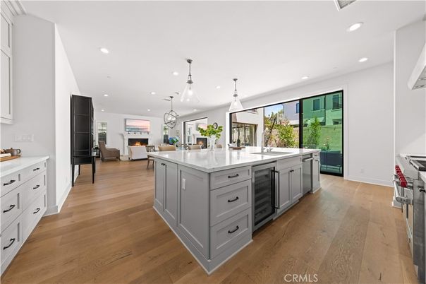 Fireplace, Interior, Kitchen, Living room, Pendant Lights, Recessed Lighting, Stainless Steel Appliances, Wood Texture Flooring