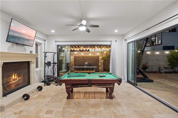 Billiard Table, Fireplace, Fitness Equipment, Game Room, Interior, Recessed Lighting, Stone Walls