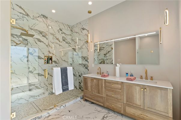 Bathroom, Dual Sink Vanities, Glass Shower, Interior, Marble, Marble Walls, Pendant Lights, Recessed Lighting