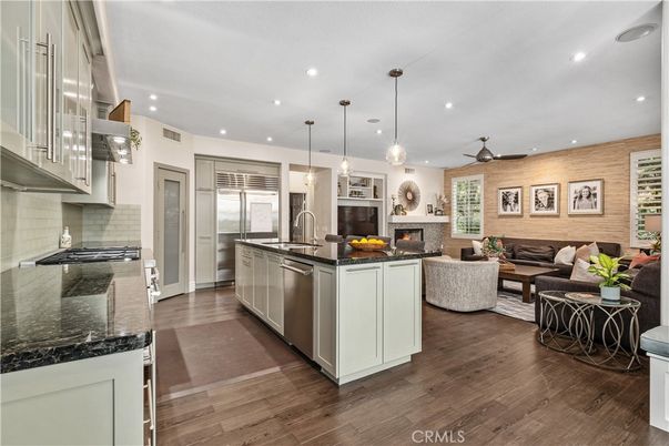 Fireplace, Interior, Kitchen, Living room, Pendant Lights, Recessed Lighting, Stainless Steel Appliances, Wood Texture Flooring