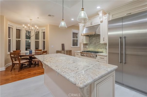 Chandelier, Dining room, Interior, Kitchen, Pendant Lights, Recessed Lighting, Stainless Steel Appliances, Wood Texture Flooring