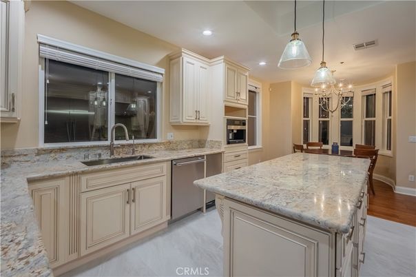 Chandelier, Dining room, Interior, Kitchen, Pendant Lights, Recessed Lighting, Stainless Steel Appliances, Wood Texture Flooring