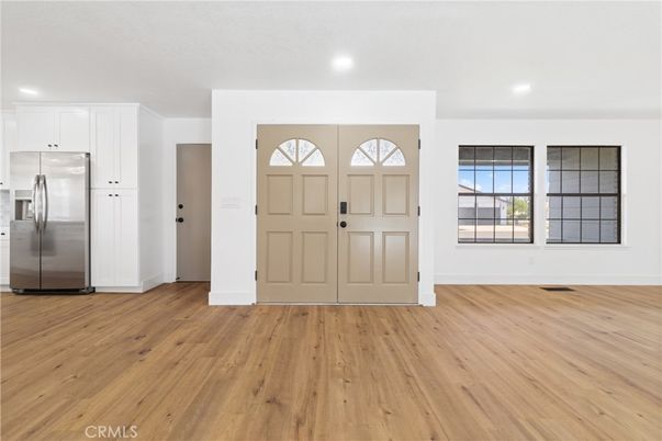 Empty room, Interior, Kitchen, Recessed Lighting, Stainless Steel Appliances, Wood Texture Flooring