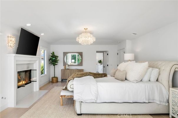 Bedroom, Chandelier, Fireplace, Interior, Recessed Lighting, Wood Texture Flooring
