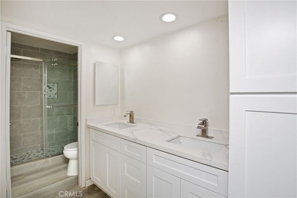 Bathroom, Dual Sink Vanities, Glass Shower, Interior, Recessed Lighting, Wood Texture Flooring
