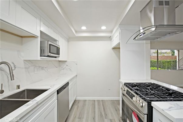 Interior, Kitchen, Marble Walls, Recessed Lighting, Stainless Steel Appliances, Wood Texture Flooring