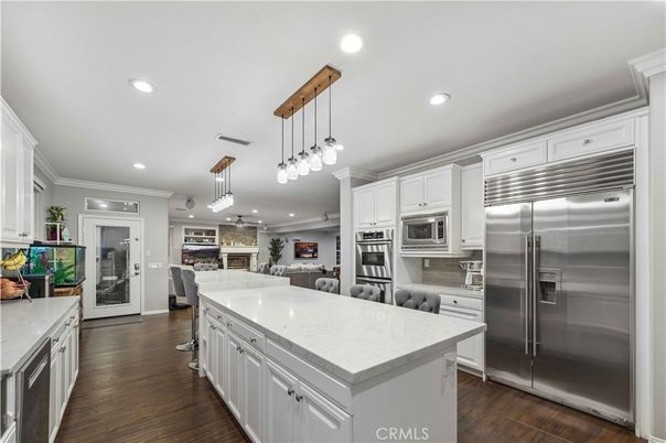 Dining room, Fireplace, Interior, Kitchen, Living room, Pendant Lights, Recessed Lighting, Stainless Steel Appliances, Wood Texture Flooring