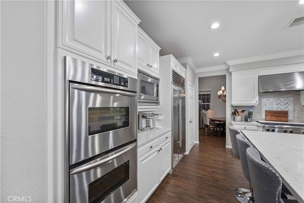 Chandelier, Dining room, Interior, Kitchen, Recessed Lighting, Stainless Steel Appliances, Wood Texture Flooring