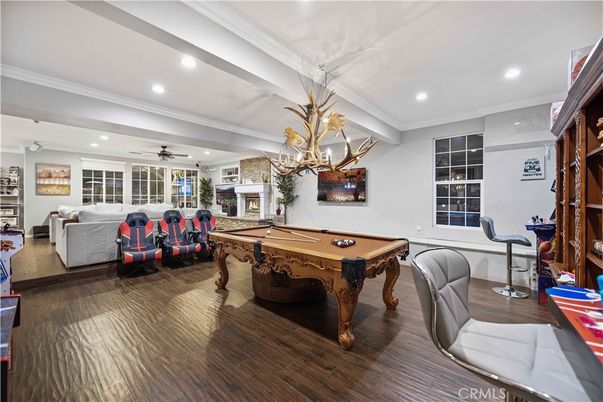 Billiard Table, Chandelier, Fireplace, Game Room, Interior, Living room, Recessed Lighting, Wood Texture Flooring