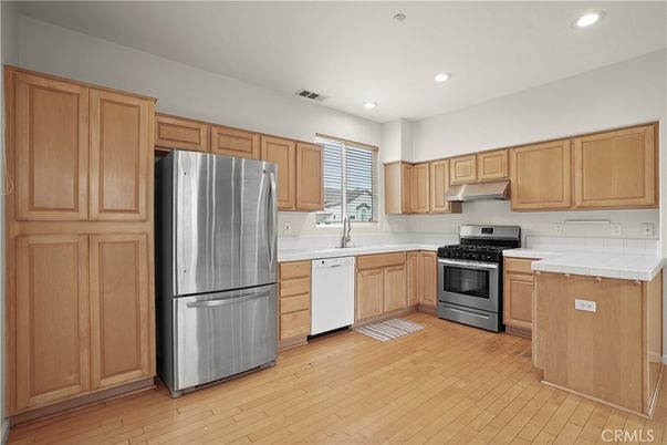 Interior, Kitchen, Recessed Lighting, Stainless Steel Appliances, Tile Countertops, Wood Texture Flooring