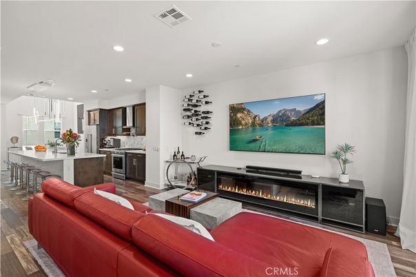 Fireplace, Interior, Kitchen, Living room, Pendant Lights, Recessed Lighting, Stainless Steel Appliances, Wood Texture Flooring