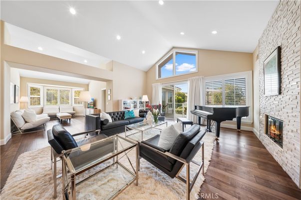 Fireplace, Interior, Living room, Piano, Recessed Lighting, Stone Walls, Wood Texture Flooring