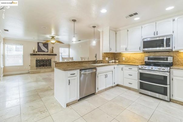 Fireplace, Interior, Kitchen, Pendant Lights, Recessed Lighting, Stainless Steel Appliances