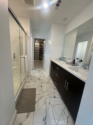 Bathroom, Dual Sink Vanities, Glass Shower, Interior, Marble, Recessed Lighting, Walk-in Closets