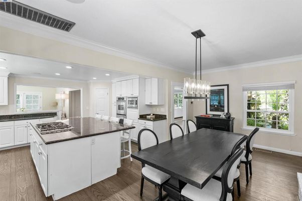 Chandelier, Dining room, Interior, Kitchen, Pendant Lights, Recessed Lighting, Stainless Steel Appliances, Wood Texture Flooring