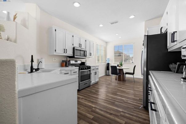 Dining room, Interior, Kitchen, Recessed Lighting, Stainless Steel Appliances, Tile Countertops, Wood Texture Flooring