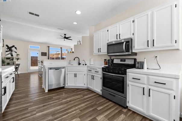 Interior, Kitchen, Recessed Lighting, Stainless Steel Appliances, Tile Countertops, Wood Texture Flooring