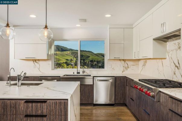 Interior, Kitchen, Marble Walls, Pendant Lights, Recessed Lighting, Stainless Steel Appliances, Wood Texture Flooring