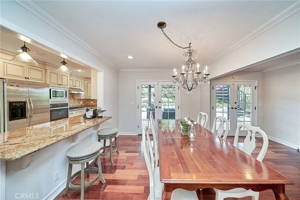 Chandelier, Dining room, Interior, Kitchen, Recessed Lighting, Stainless Steel Appliances, Wood Texture Flooring