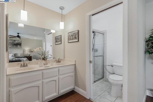 Bathroom, Bedroom, Dual Sink Vanities, Glass Shower, Interior, Pendant Lights, Recessed Lighting, Wood Texture Flooring