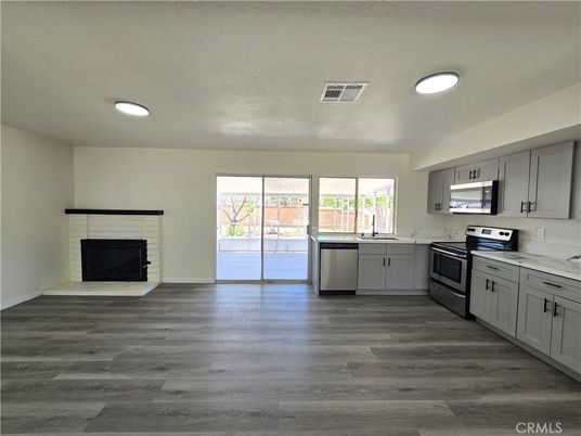 Fireplace, Interior, Kitchen, Stainless Steel Appliances, Wood Texture Flooring