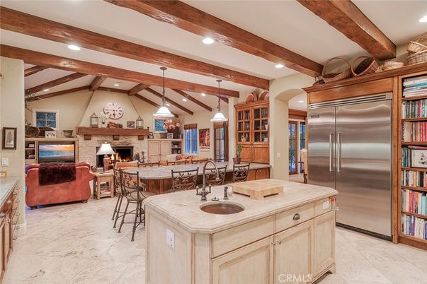 Fireplace, Interior, Kitchen, Living room, Pendant Lights, Recessed Lighting, Stainless Steel Appliances, Stone Walls, Wooden Beams