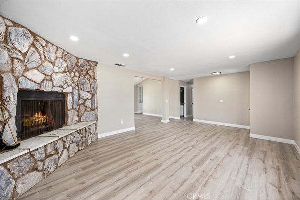 Empty room, Fireplace, Interior, Recessed Lighting, Stone Walls, Wood Texture Flooring