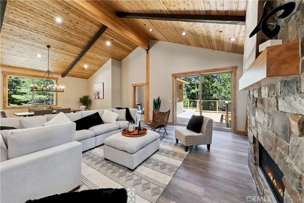 Chandelier, Dining room, Fireplace, Interior, Living room, Pendant Lights, Recessed Lighting, Stone Walls, Wooden Beams, Wooden Ceilings, Wood Texture Flooring