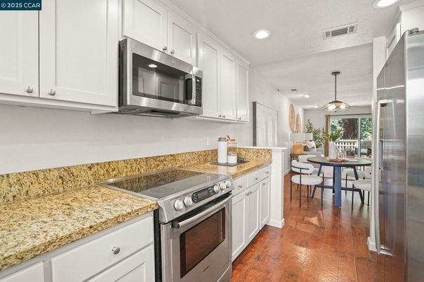 Dining room, Interior, Kitchen, Pendant Lights, Recessed Lighting, Stainless Steel Appliances, Wood Texture Flooring
