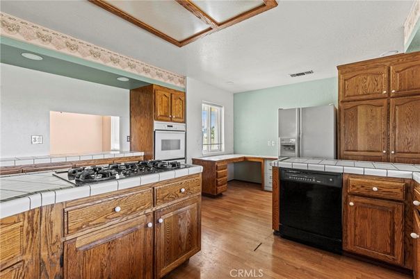 Interior, Kitchen, Recessed Lighting, Tile Countertops, Wood Texture Flooring