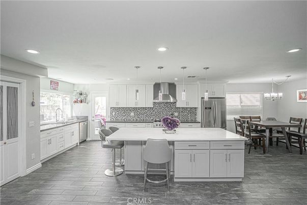 Chandelier, Dining room, Interior, Kitchen, Pendant Lights, Recessed Lighting, Stainless Steel Appliances, Wood Texture Flooring