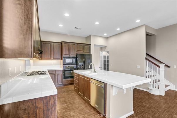 Interior, Kitchen, Recessed Lighting, Stainless Steel Appliances, Tile Countertops, Wood Texture Flooring