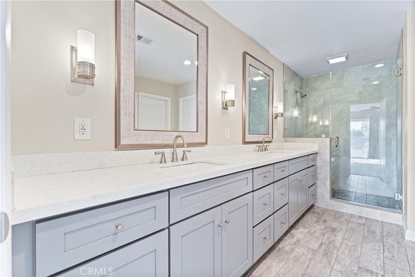 Bathroom, Dual Sink Vanities, Glass Shower, Interior, Recessed Lighting, Wood Texture Flooring