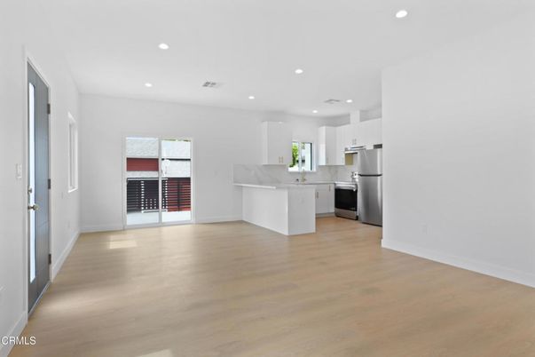 Empty room, Interior, Kitchen, Recessed Lighting, Stainless Steel Appliances, Wood Texture Flooring