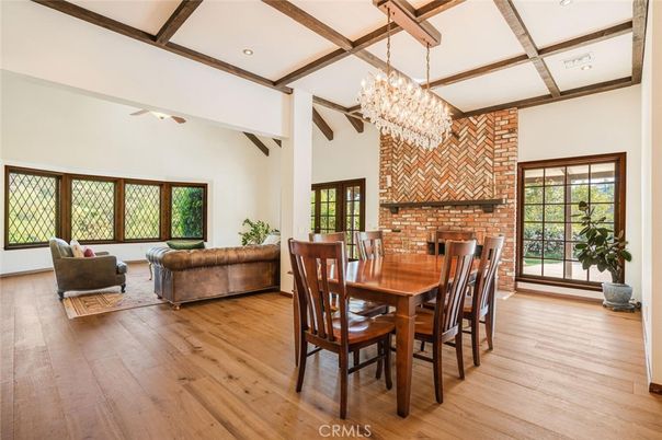 Chandelier, Dining room, Fireplace, Interior, Living room, Recessed Lighting, Stone Walls, Wooden Beams, Wood Texture Flooring