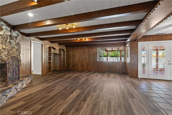 Empty room, Fireplace, Interior, Stone Walls, Wooden Beams, Wood Texture Flooring