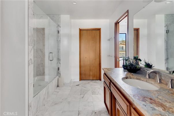 Bathroom, Dual Sink Vanities, Glass Shower, Interior, Marble, Marble Walls, Recessed Lighting