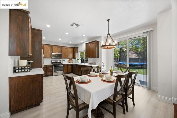 Dining room, Interior, Kitchen, Pendant Lights, Recessed Lighting, Stainless Steel Appliances, Wood Texture Flooring