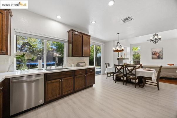 Chandelier, Dining room, Interior, Kitchen, Pendant Lights, Recessed Lighting, Stainless Steel Appliances, Wood Texture Flooring