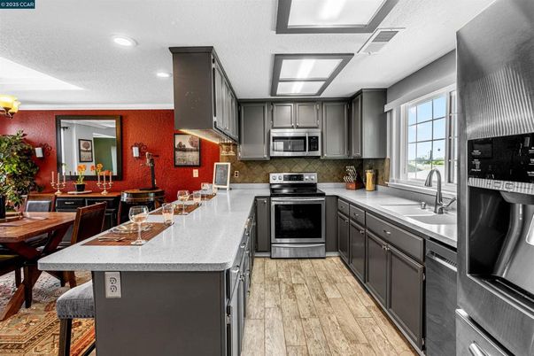 Dining room, Interior, Kitchen, Recessed Lighting, Stainless Steel Appliances, Wood Texture Flooring