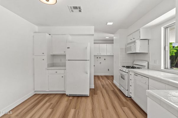 Interior, Kitchen, Recessed Lighting, Tile Countertops, Wood Texture Flooring