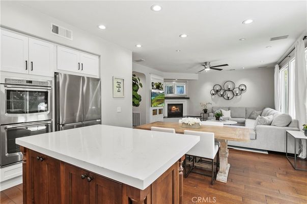 Fireplace, Interior, Kitchen, Living room, Recessed Lighting, Stainless Steel Appliances, Wood Texture Flooring
