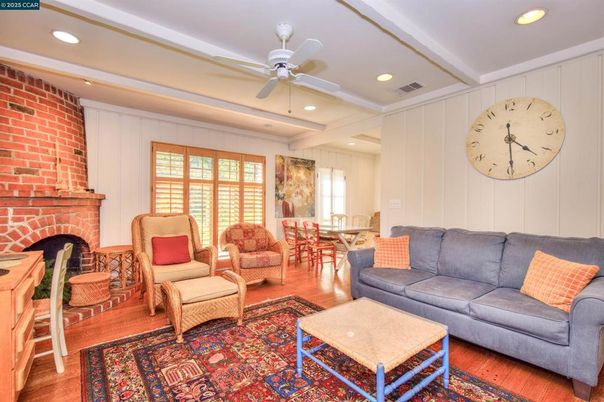 Dining room, Fireplace, Interior, Living room, Recessed Lighting, Stone Walls, Wood Texture Flooring