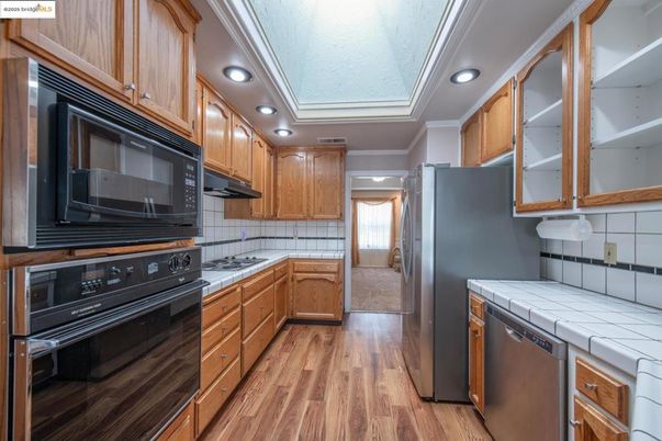 Interior, Kitchen, Recessed Lighting, Tile Countertops, Wood Texture Flooring