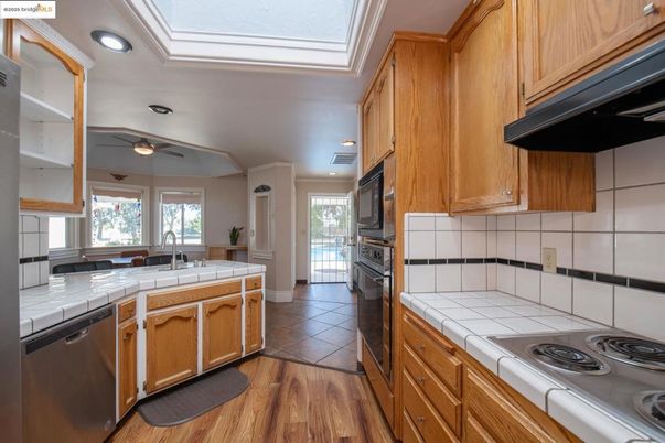 Interior, Kitchen, Recessed Lighting, Tile Countertops, Wood Texture Flooring