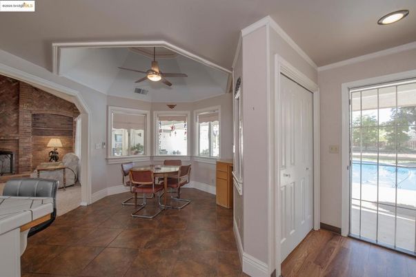 Dining room, Fireplace, Interior, Recessed Lighting, Stone Walls, Wood Texture Flooring