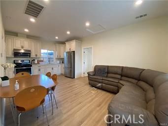 Dining room, Interior, Kitchen, Living room, Recessed Lighting, Stainless Steel Appliances, Wood Texture Flooring