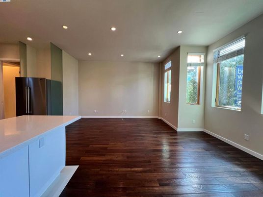 Empty room, Interior, Kitchen, Recessed Lighting, Stainless Steel Appliances, Wood Texture Flooring