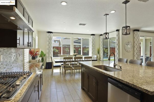 Dining room, Interior, Kitchen, Pendant Lights, Recessed Lighting, Stainless Steel Appliances, Wood Texture Flooring